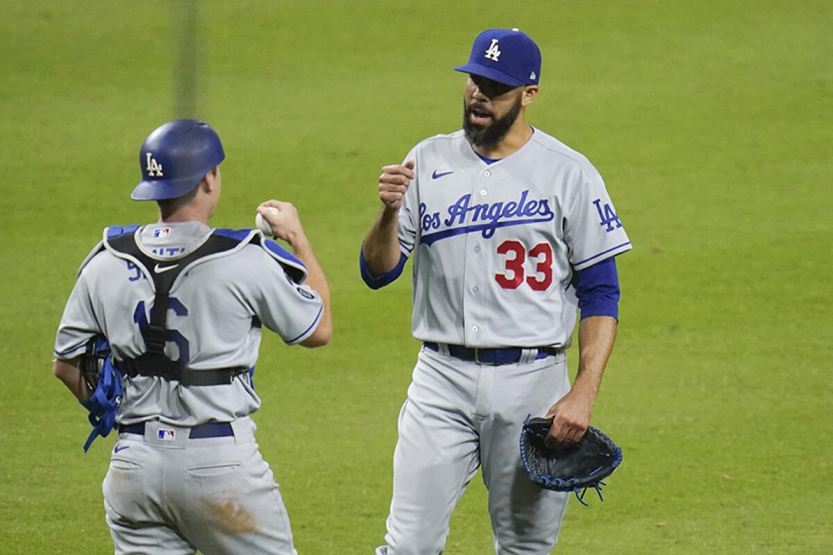 Dodgers reliever David Price and catcher Will Smith celebrate after shutting down the Padres in the 12th inning