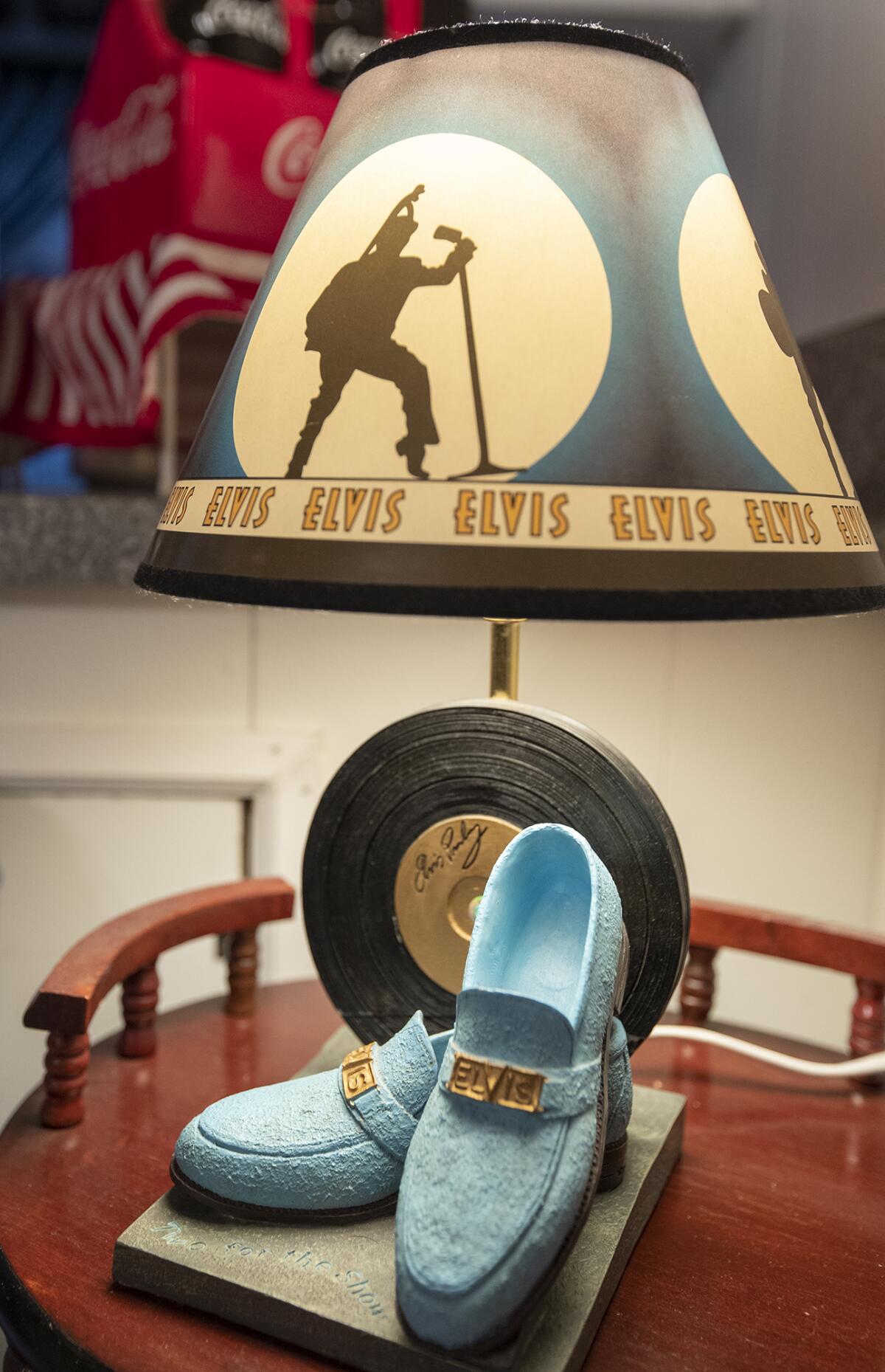 A pair of blue suede shoes sit below an Elvis lamp in Sylvia Ronquillo and Jesse Nava's home.