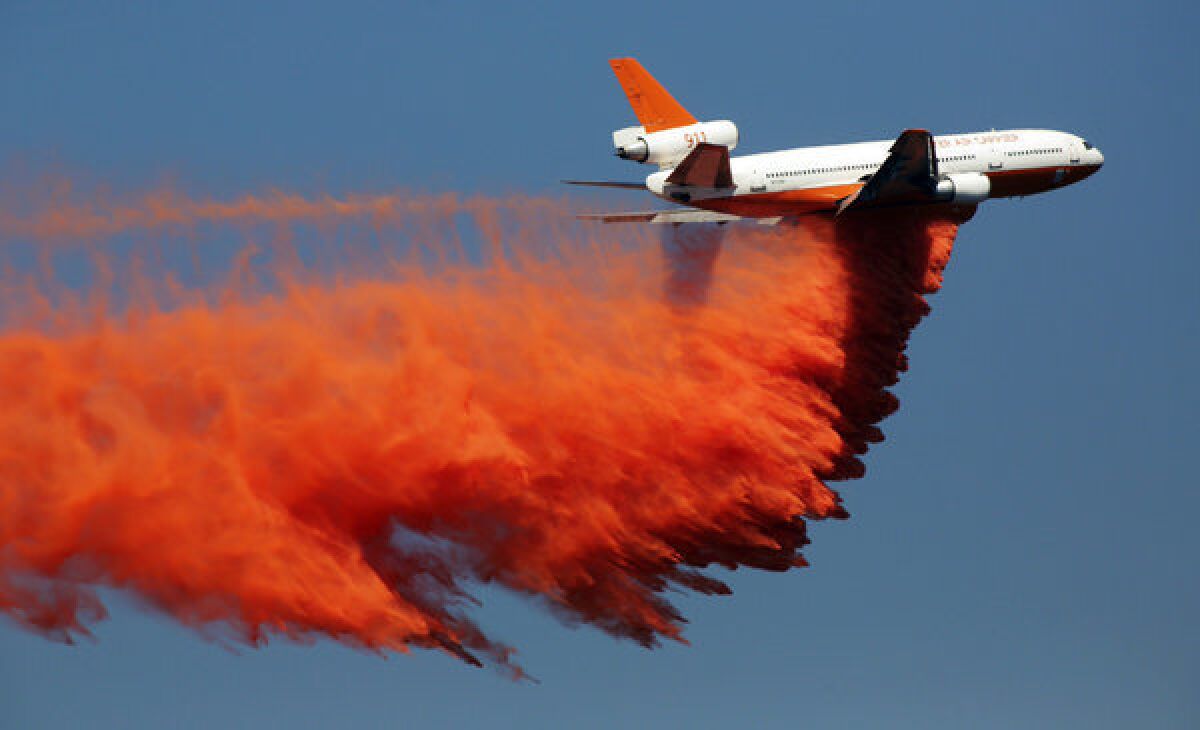 A DC-10 drops retardant Tuesday on the Madre fire in the Angeles National Forest above Azusa. A DC-10 was also used to battle the Sierra fire in the Cajon Pass.