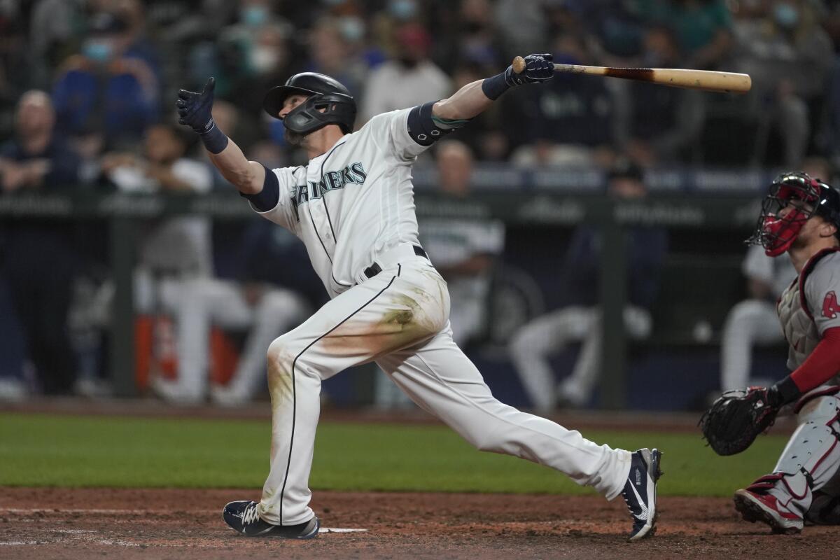 Seattle Mariners' Mitch Haniger follows through on a three-run go-ahead home run against the Boston Red Sox during the seventh inning of a baseball game, Monday, Sept. 13, 2021, in Seattle. (AP Photo/Ted S. Warren)