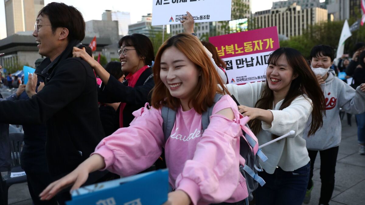 South Koreans who support the upcoming inter-Korean summit cheer at a rally in Seoul on Saturday.