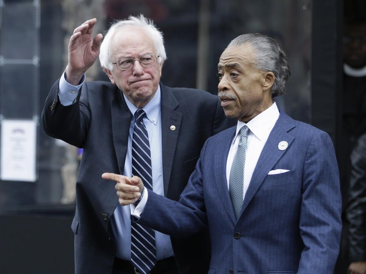 Democratic presidential candidate Sen. Bernie Sanders of Vermont waves to media and supporters after a breakfast meeting with the Rev. Al Sharpton at Sylvia's Restaurant in New York's Harlem.