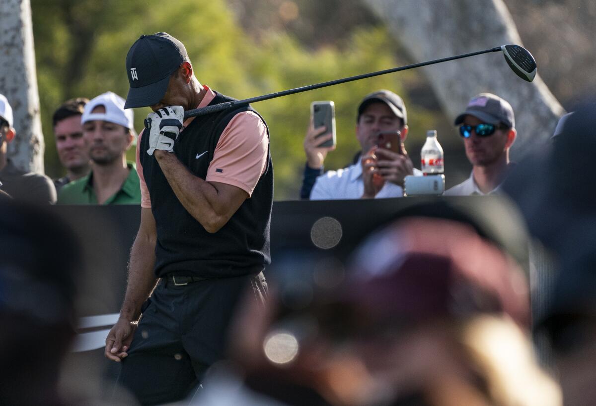 Tiger Woods reacts after hitting a stray tee during the first round of the Genesis Invitational on Feb. 13, 2020.