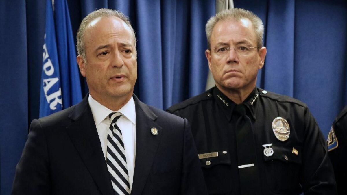 At a news conference Monday, LAPD Chief Michel Moore, right, looks on as U.S. Atty. Nick Hanna discusses the arrest of a man suspected of planning attacks on "multiple targets" in Southern California.