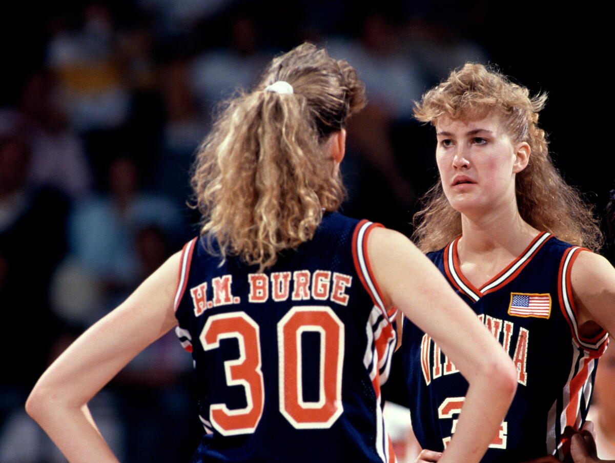 Heidi Burge looking astatine her copy sister Heather Burge connected a hoops court