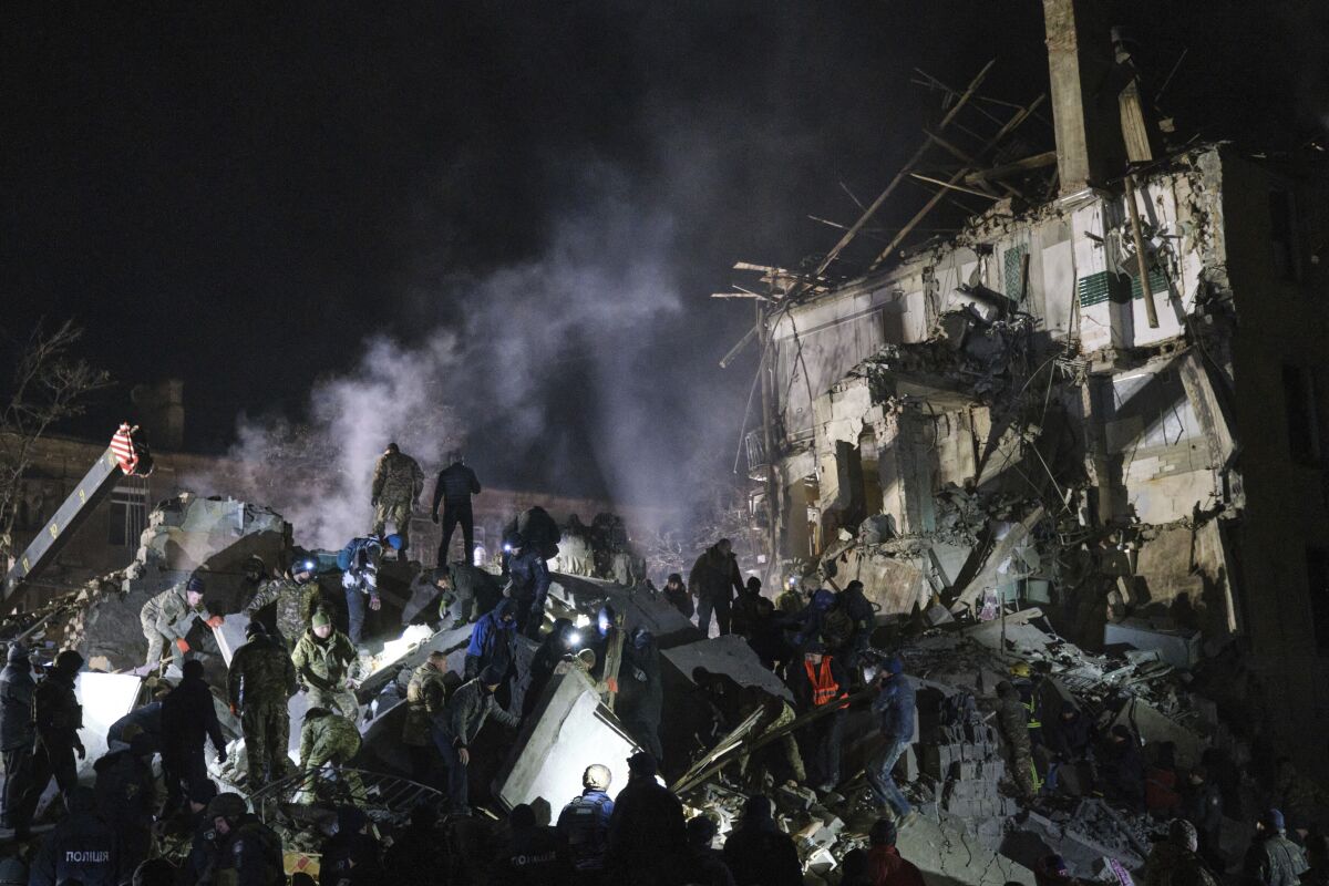 Emergency workers clearing rubble of apartment building in Kramatorsk, Ukraine