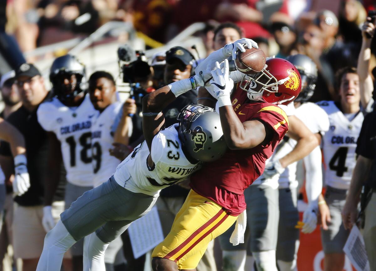 USC receiver Darreus Rogers (1) wrestles the ball away from Colorado's Ahkello Witherspoon, turning a potential interception into a 46-yard reception to set up the Trojans' go-ahead touchdown on Oct. 8.