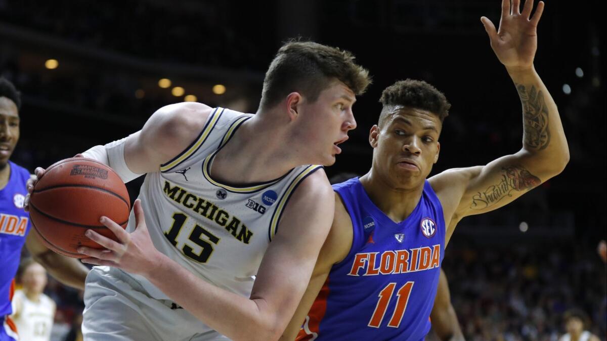 Michigan center Jon Teske (15) grabs a rebound in front of Florida forward Keyontae Johnson during the second round of the NCAA tournament on Saturday in Des Moines, Iowa.