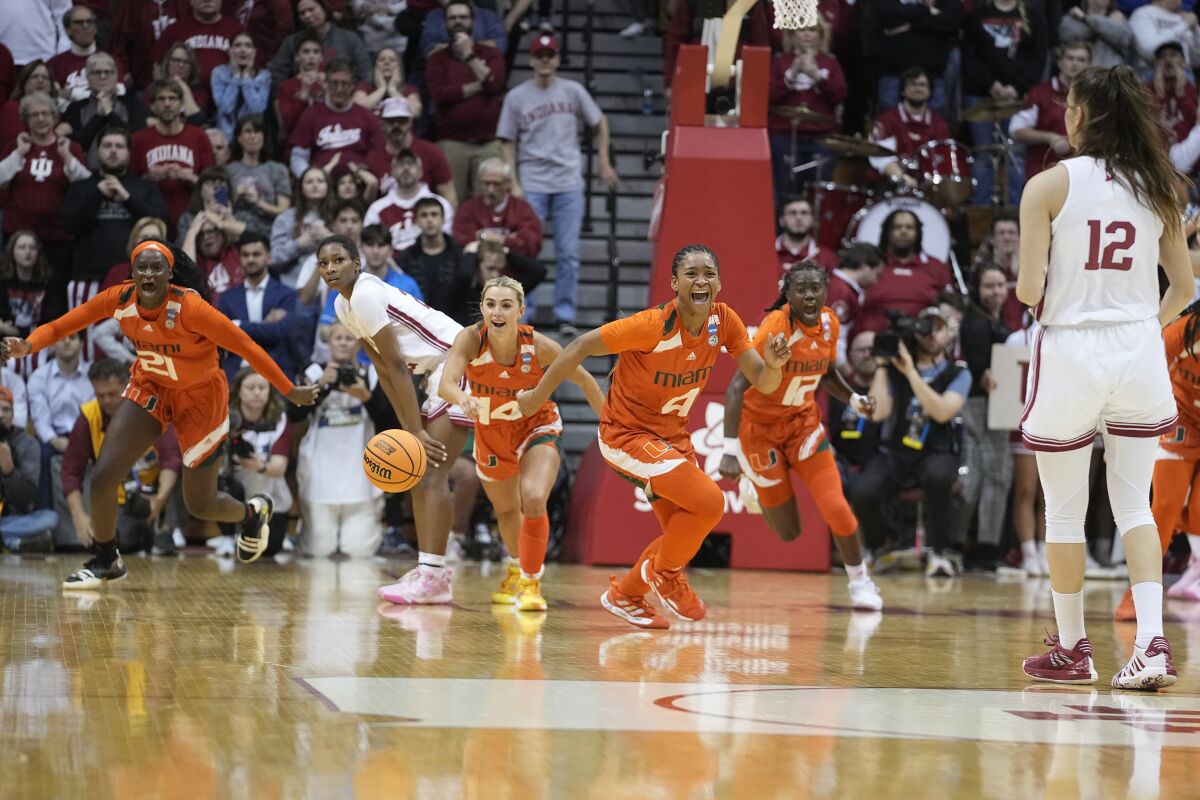 Miami's Jasmyne Roberts (4) and Haley Cavinder (14) react after Miami defeated Indiana in a second-round college basketball game in the women's NCAA Tournament Monday, March 20, 2023, in Bloomington, Ind. (AP Photo/Darron Cummings)
