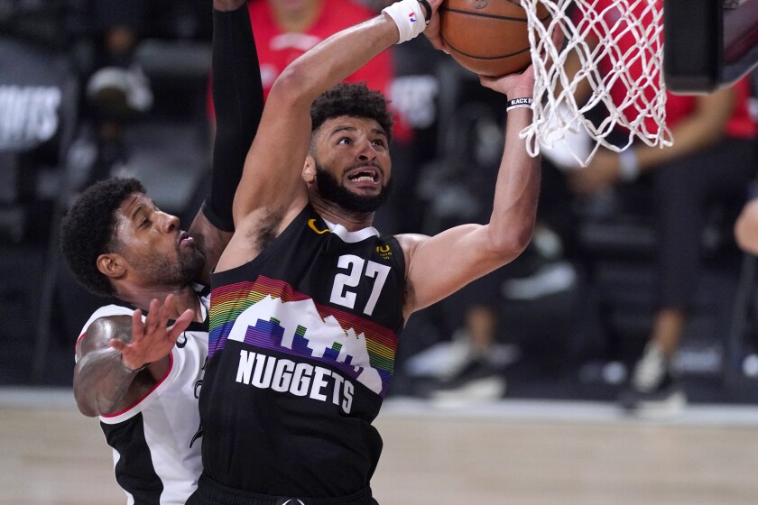 Nuggets guard Jamal Murray goes up for a shot as Clippers forward Paul George defends during Game 6 on Sunday.