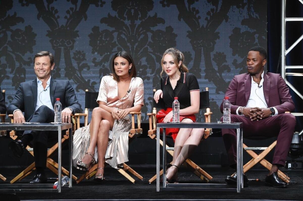 The cast of CW's reboot of "Dynasty," from left: Grant Show, Nathalie Kelley, Elizabeth Gillies and Sam Adegoke.