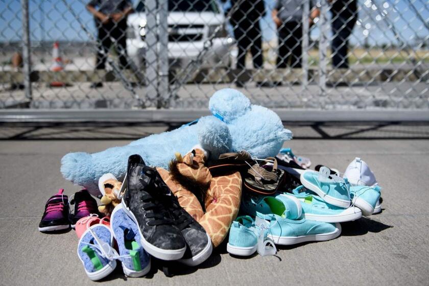 (FILES) In this file photo taken on June 21, 2018 (FILES) This June 21, 2018 file photo shows security personal standing before shoes and toys left at the Tornillo Port of Entry in Tornillo, Texas where minors crossing the border without proper papers have been housed after being separated from adults. Hundreds of immigrant parents and children separated at the US-Mexico border were in limbo on July 26, 2018, as American officials struggled to meet a court-set deadline for family reunification that was set to expire. A federal judge in California has ordered that all eligible migrant families be brought back together by 6:00 pm (2200 GMT) Thursday July 26, 2018. / AFP PHOTO / Brendan SmialowskiBRENDAN SMIALOWSKI/AFP/Getty Images ** OUTS - ELSENT, FPG, CM - OUTS * NM, PH, VA if sourced by CT, LA or MoD **