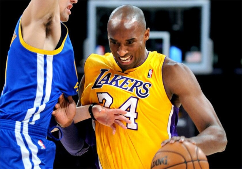 Kobe Bryant drives the lane against Klay Thompson at Staples Center on Friday.