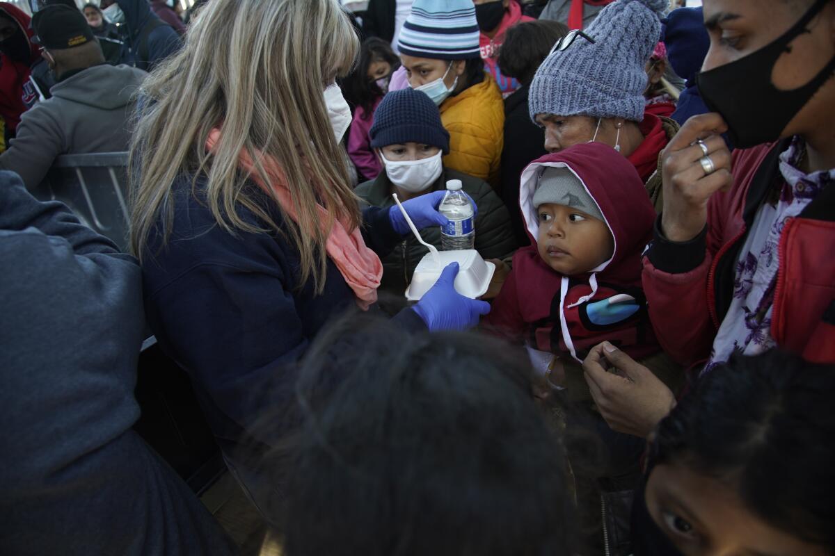Asylum seekers gather at a border crossing.