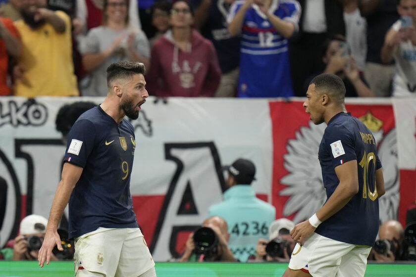 France's Olivier Giroud celebrates after scoring his side's first goal with France's Kylian Mbappe during the World Cup round of 16 soccer match between France and Poland, at the Al Thumama Stadium in Doha, Qatar, Sunday, Dec. 4, 2022. (AP Photo/Moises Castillo)