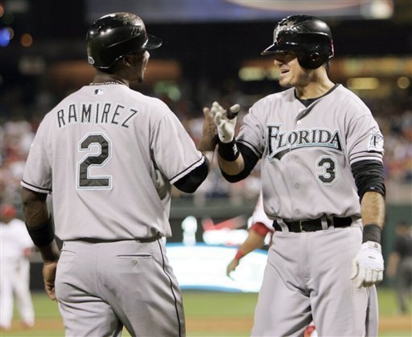 Florida Marlins' Hanley Ramirez, left, greets Jorge Cantu who hit a three-run home run in the second inning of a baseball game against the Philadelphia Phillies, Tuesday, Sept. 9, 2008, in Philadelphia. (AP Photo/Tom Mihalek)