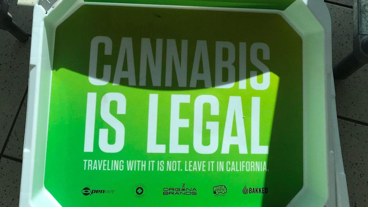 An airport security tray has a public service announcement from cannabis manufacturer Organa Brands. Starting Jan. 1, the recreational use of cannabis by those 21 and older will be legal in California