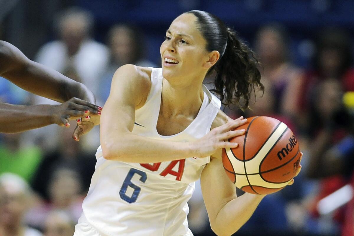 FILE - United States' Sue Bird, right, is defended during the first half of a women's exhibition basketball game against Canada in Bridgeport, Conn., in this Friday, July 29, 2016, file photo. Sue Bird and Diana Taurasi will try and become the first five-time Olympic gold medalists in basketball as they lead the U.S women's team at the Tokyo Games. The duo was selected for their fifth Olympics on Monday, June 21, 2021, joining Teresa Edwards as the only basketball players in U.S. history to play in five.(AP Photo/Jessica Hill, FIle)
