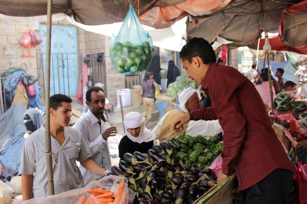 Residents of the city of Taizz in southwestern Yemen take advantage of a five-day humanitarian cease-fire to buy vegetables at a market on May 13.