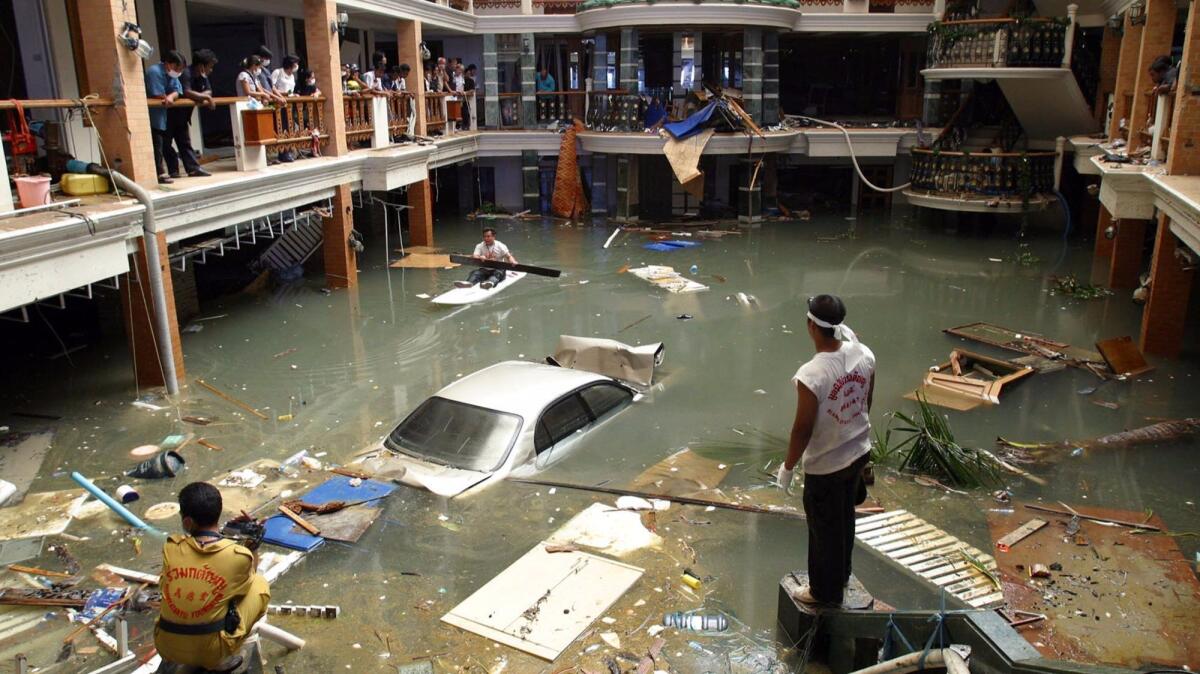 Rescue and cleanup crews survey a flooded lobby at a hotel on Phuket Island in 2004 after massive tsunami waves smashed coastlines. (Deddeda Stemler / Canadian Press)
