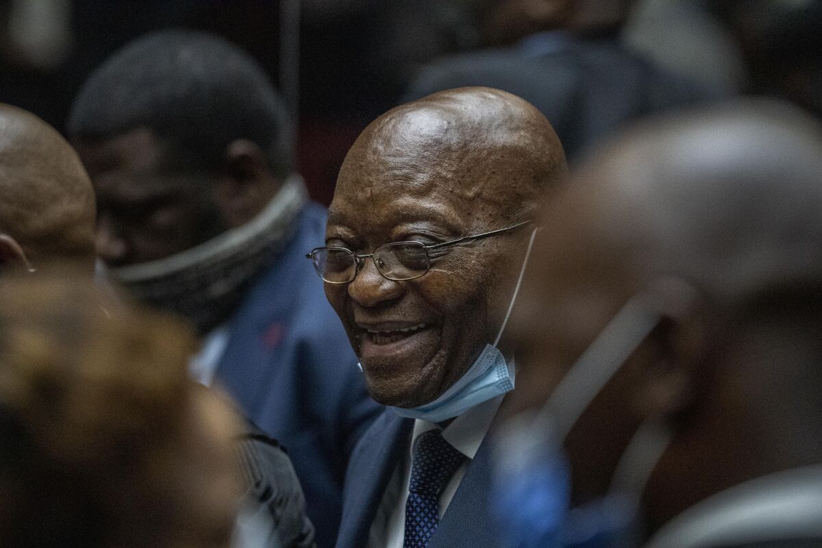 FILE — Former South African President Jacob Zuma consults with his legal team during a recess at the High Court in Pietermaritzburg, South Africa, Monday Jan. 31, 2022. The court has dismissed Zuma's attempt to remove the prosecutor from his upcoming corruption trial. (AP Photo/Jerome Delay,Pool)