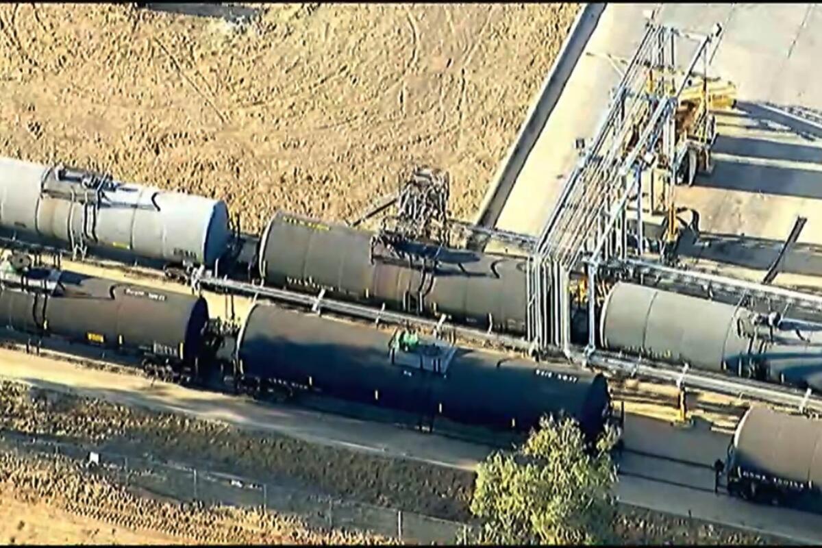 This image taken from video provided by ABC7 Los Angeles, shows the scene where a railroad tank car is leaking near Perris, Calif., Friday, Aug. 12, 2022. A Southern California freeway has been closed and nearby homes are evacuated as a chemical reaction inside a railroad tank car threatens to cause an explosion. The tank car is parked on a spur off a main rail line alongside Interstate 215 in Riverside County, about 57 miles east of Los Angeles. (ABC7 Los Angeles via AP)