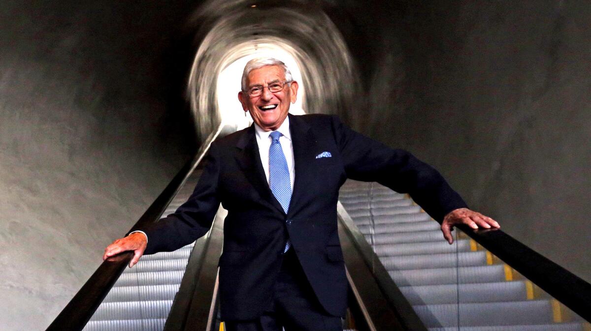 Eli Broad stands on an escalator in the Broad museum.
