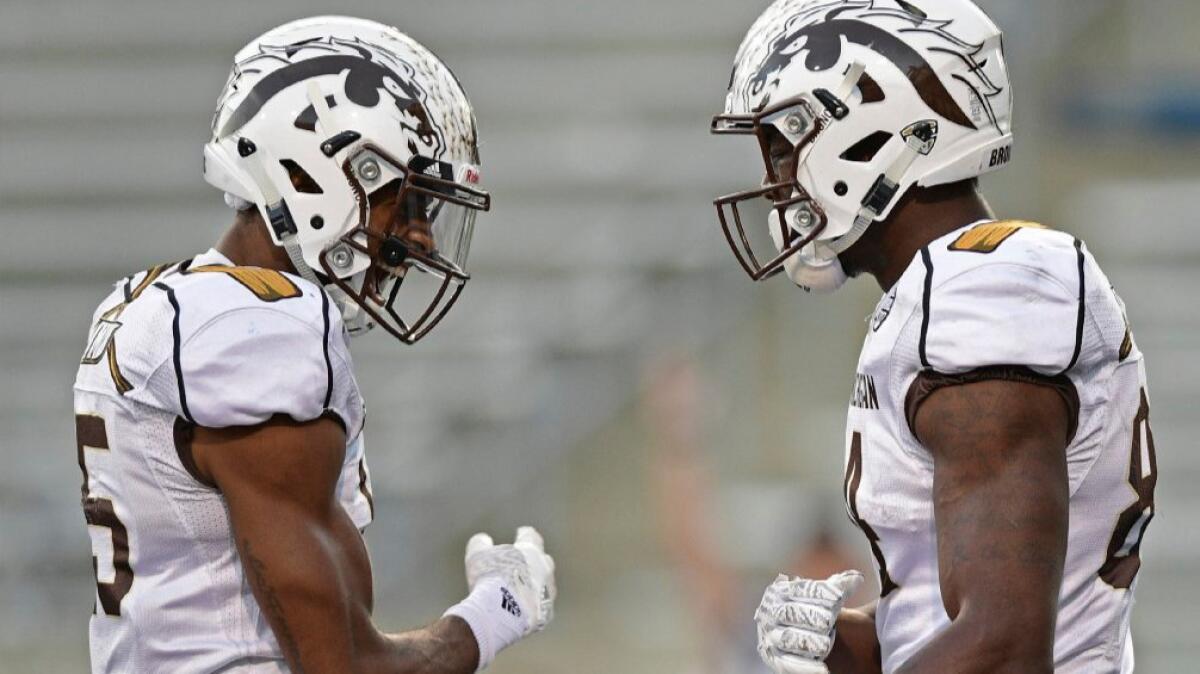 Western Michigan receiver Corey Davis celebrates with fellow receiver Carrington Thompson, left, after scoring a touchdown against Akron on Saturday.