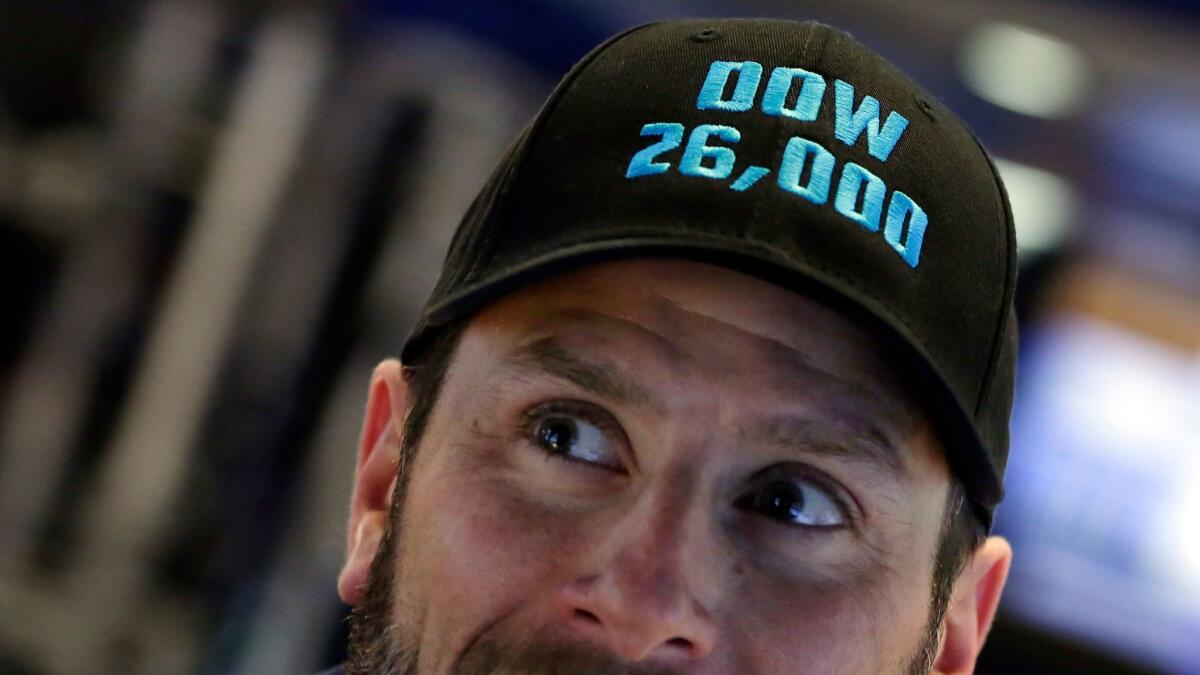 Specialist Michael Pistillo marks the day as he works on the floor of the New York Stock Exchange.