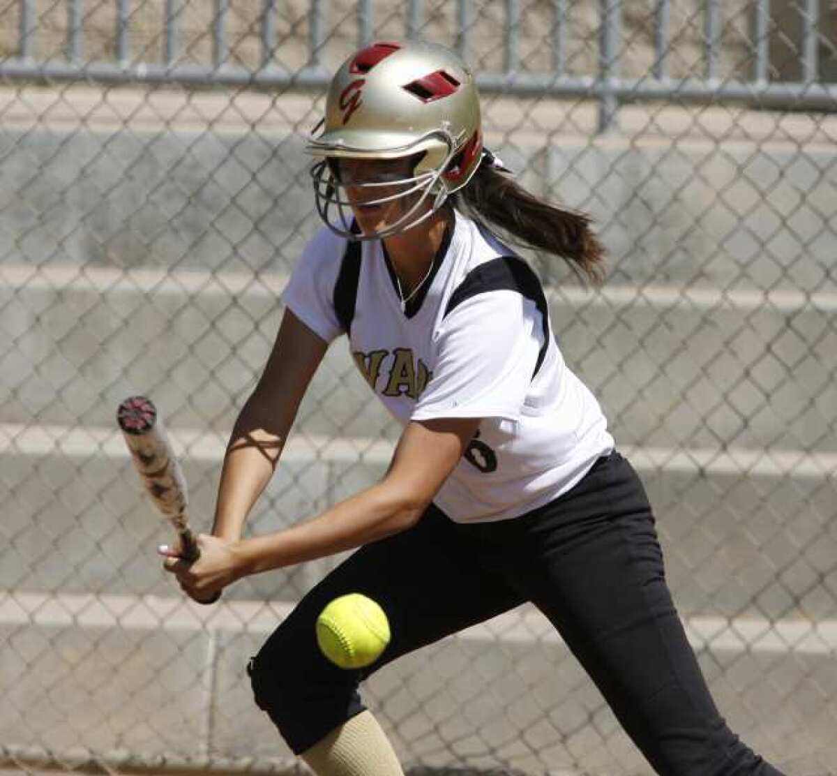 Glendale Community College's Claire Ortiz goes for a slap hit in a game with Bakersfield College.