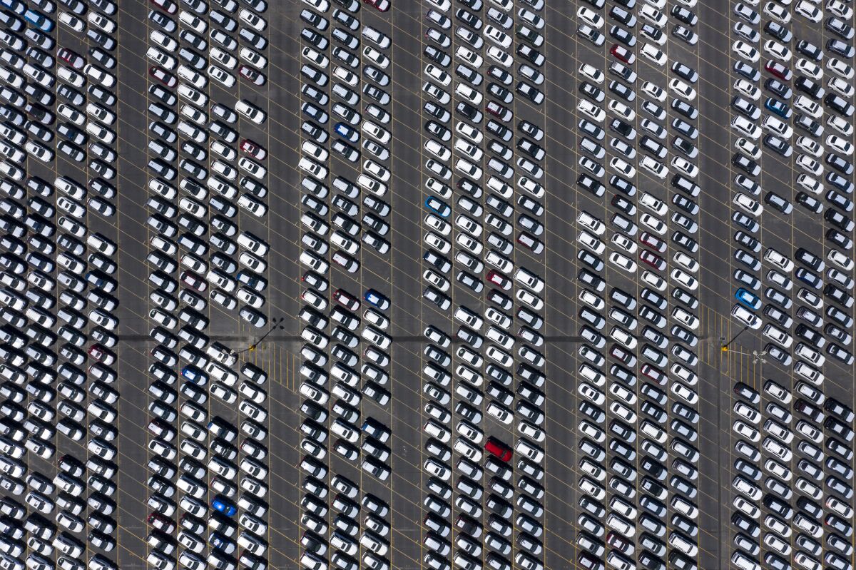 An aerial view of myriad cars in a parking lot. 
