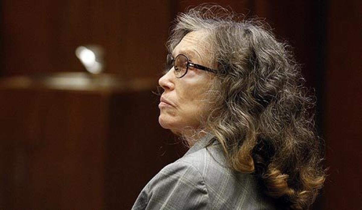 Helen Golay, 77, listens to her attorney in the Criminal Courts Building in downtown Los Angeles. She and Olga Rutterschmidt, 75, are accused of taking out at least 19 life insurance policies on two homeless men and then killing them.