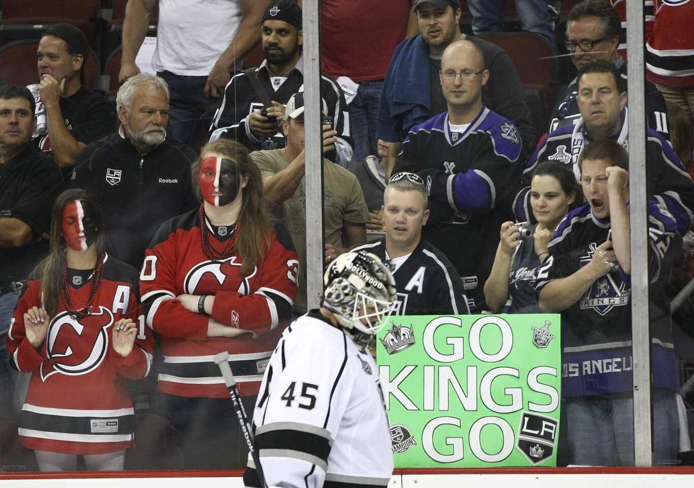 A group of Kings fans show their support as Kings backup goalie Jonathan Bernier warms up before the start of Game 1 of the Stanley Cup Final in Newark, N.J., on Wednesday.