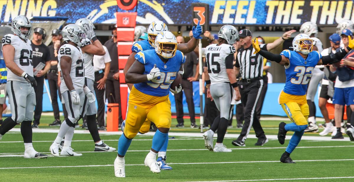 The Chargers celebrate after Poona Ford's (95) interception sealed a victory over the Raiders. 