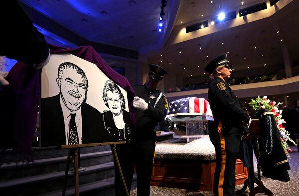 An image of Kaufman County Dist. Atty. Mike McLelland and his wife, Cynthia, is unveiled before a memorial service for them in Sunnyvale, Texas.