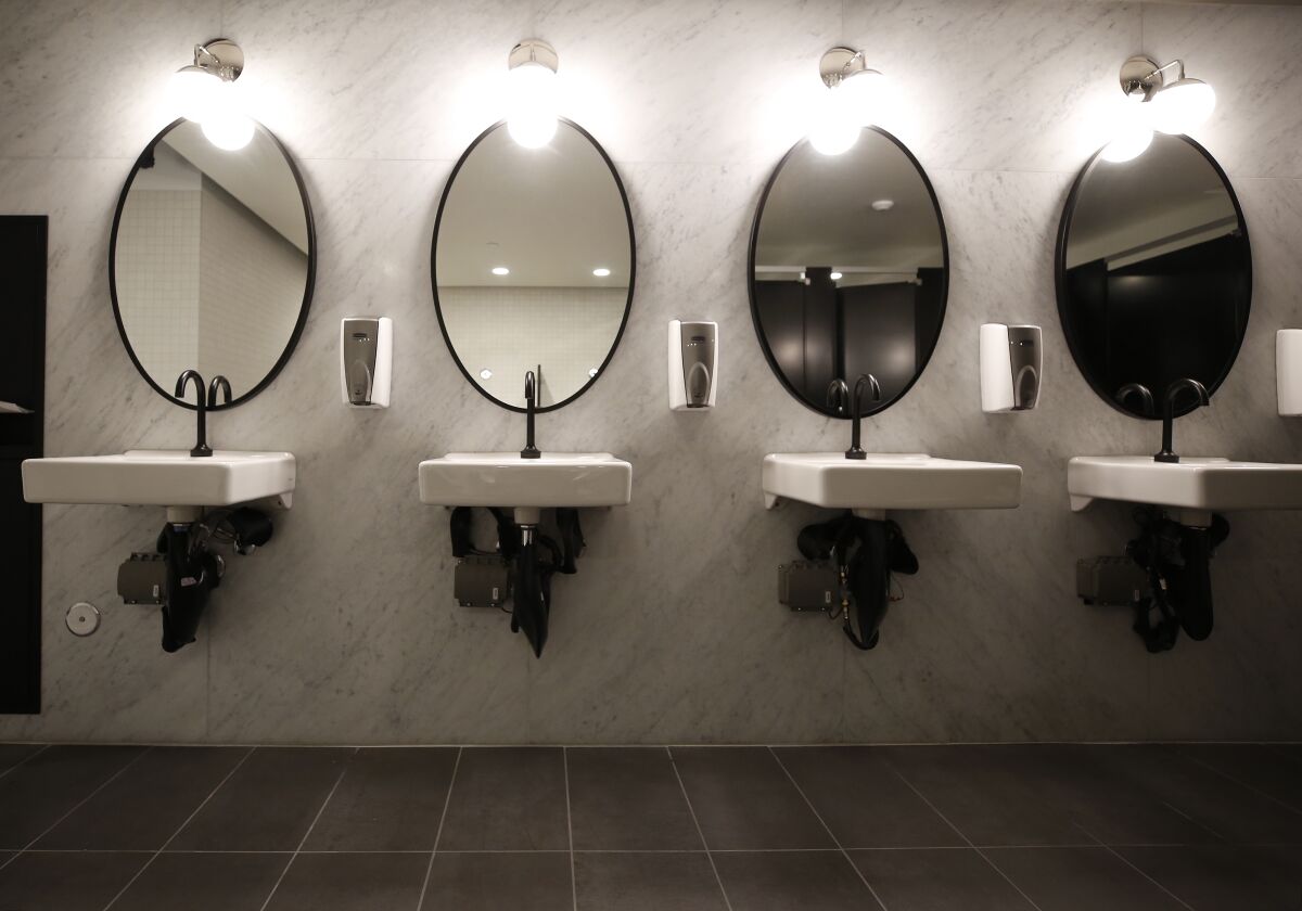 Original marble dividers from restrooms were repurposed for a wall backdrop in new restrooms.