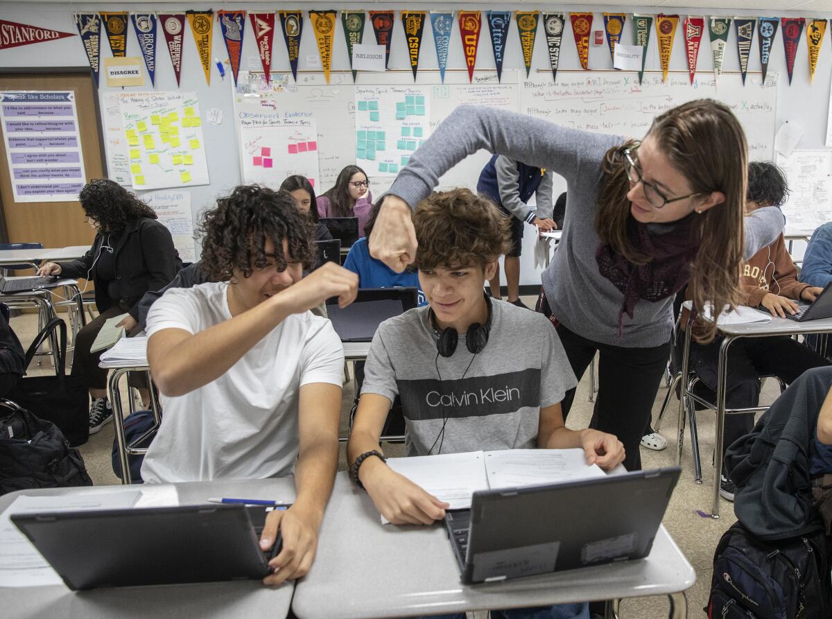 William Lopez Rodas a 10th grader at Birmingham High School, receives a fist bump from his teacher, Lindsay Humphrey.