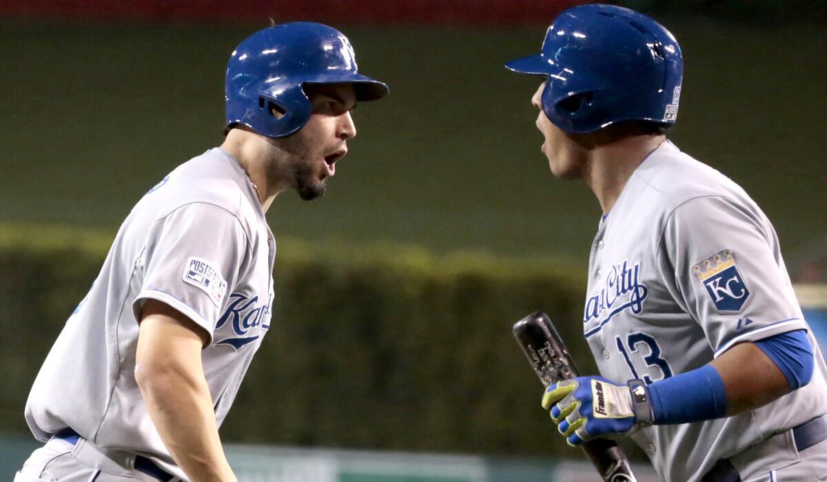Royals first baseman Eric Hosmer is congratulated by teammate Salvador Perez after scoring against the Angels in the second inning of Game 2 on Friday night in Anaheim.