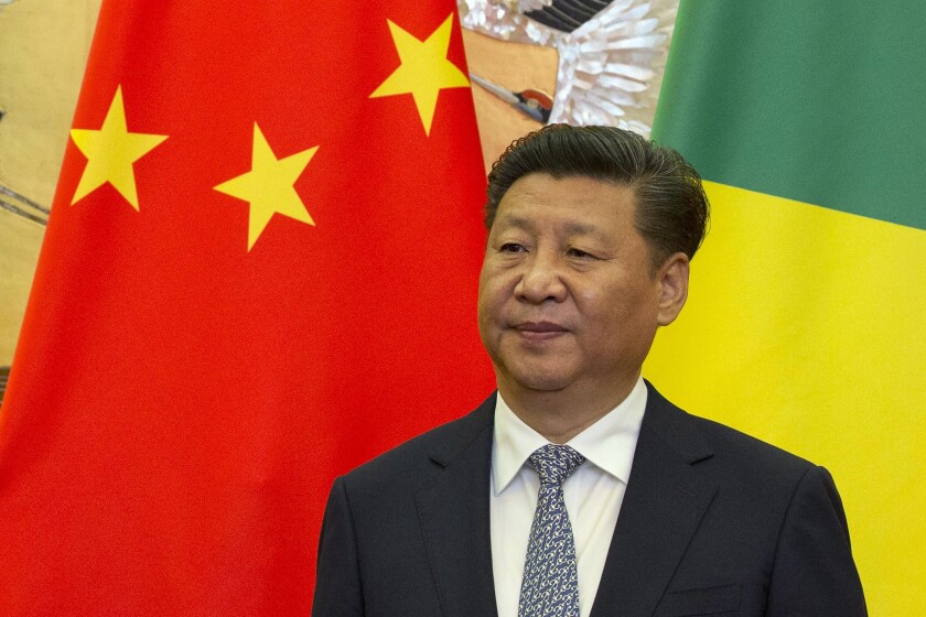 FILE - Chinese President Xi Jinping stands in front of national flags of China and Republic of Congo during a meeting with visting Congolese dignitaries at the Great Hall of the People in Beijing, China, Tuesday, July 5, 2016. China on Wednesday, Dec. 1, 2021, urged its citizens to leave three provinces in eastern Congo as violence intensifies in the mineral-rich region. (AP Photo/Ng Han Guan, Pool, File)