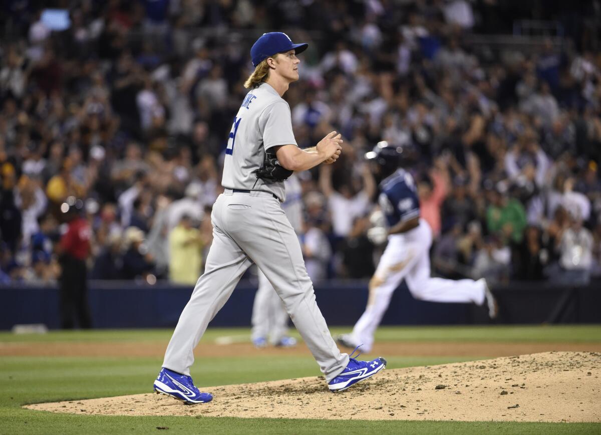 Dodgers pitcher Zack Greinke walks back to the mound after giving up a solo home run to San Diego's Justin Upton in the eighth inning Saturday night.