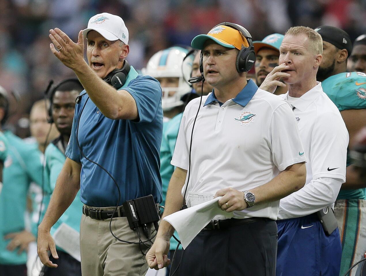Miami Dolphins head coach Joe Philbin, left, gestures during the NFL football game between the New York Jets and the Miami Dolphins and at Wembley stadium in London, Sunday, Oct. 4, 2015. (AP Photo/Tim Ireland) ORG XMIT: WEM185