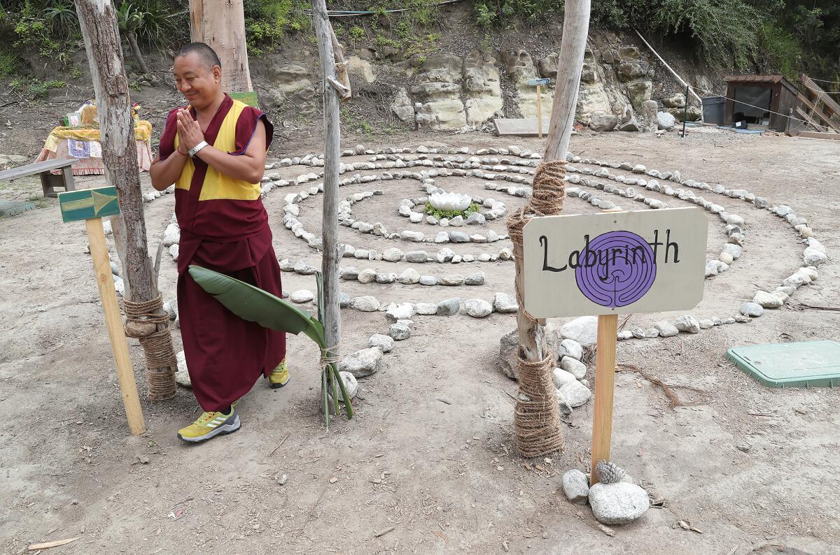 A Drepung Gomang monk finishes a walk around the labyrinth path made in honor of their visit.