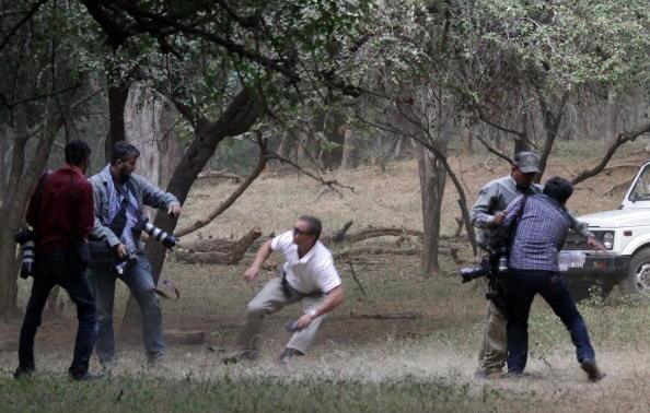 This picture taken on October 22, 2010 shows a bodyguard (C, white shirt) of British comic-turned-Hollywood star Russell Brand (unseen) clashing with news photographers while a security guard holds AFP photographer Manan Vatsyayana (R) at the Ranthambore National Park in Ranthambore around 200kms from Jaipur on October 22, 2010. Tight security is in place on October 23 for the pending nuptials between British comic-turned-Hollywood star Russell Brand and US pop star Katy Perry. The couple will reportedly marry in a Hindu ceremony in the Ranthambore tiger reserve in the north Indian state of Rajasthan.
