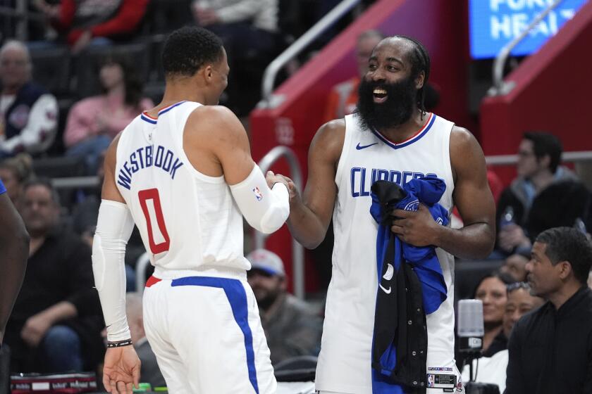 Clippers guard Russell Westbrook celebrates with James Harden as he exits a game against the Detroit Pistons 