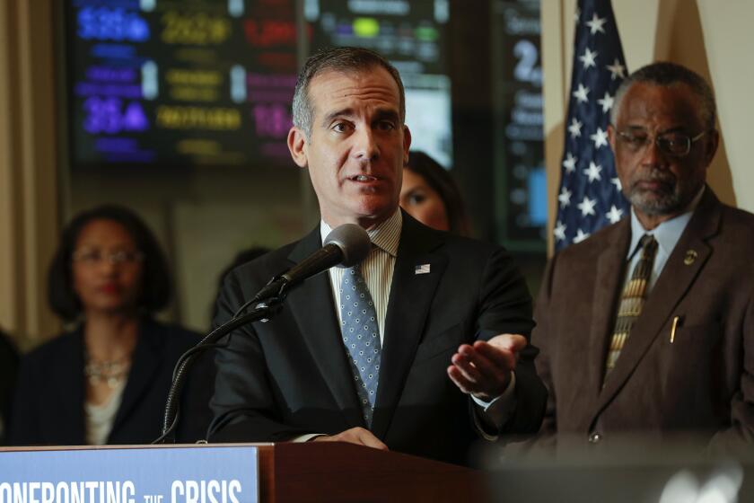 LOS ANGELES, CA - FEBRUARY 06 , 2020 - Los Angeles Mayor Eric Garcetti, flanked by Councilman Curren Price, right, and other officials speaks at a news conference on Thursday morning February 06, 2020, to discuss the city's efforts to address the homelessness crisis. Press conference was held at Unified Homelessness Response Center at Emergency Operations Center. (Irfan Khan / Los Angeles Times)