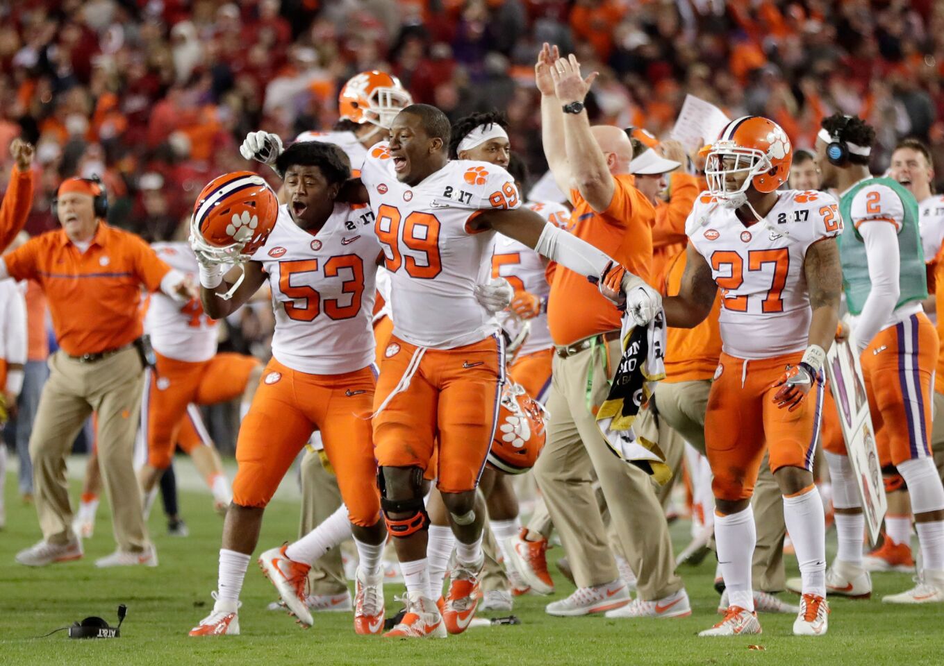 Clemson player celebrate along the sideline after quarterback Deshaun Watson (not pictured) threw a two-yard touchdown pass with one second left to receiver Hunter Renfrow (not pictured).