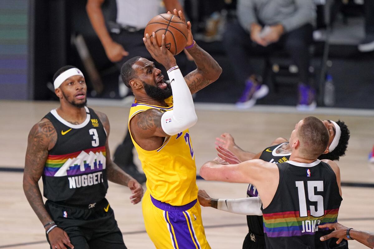 Lakers forward LeBron James looks to score against Nuggets center Nikola Jokic during Game 4.