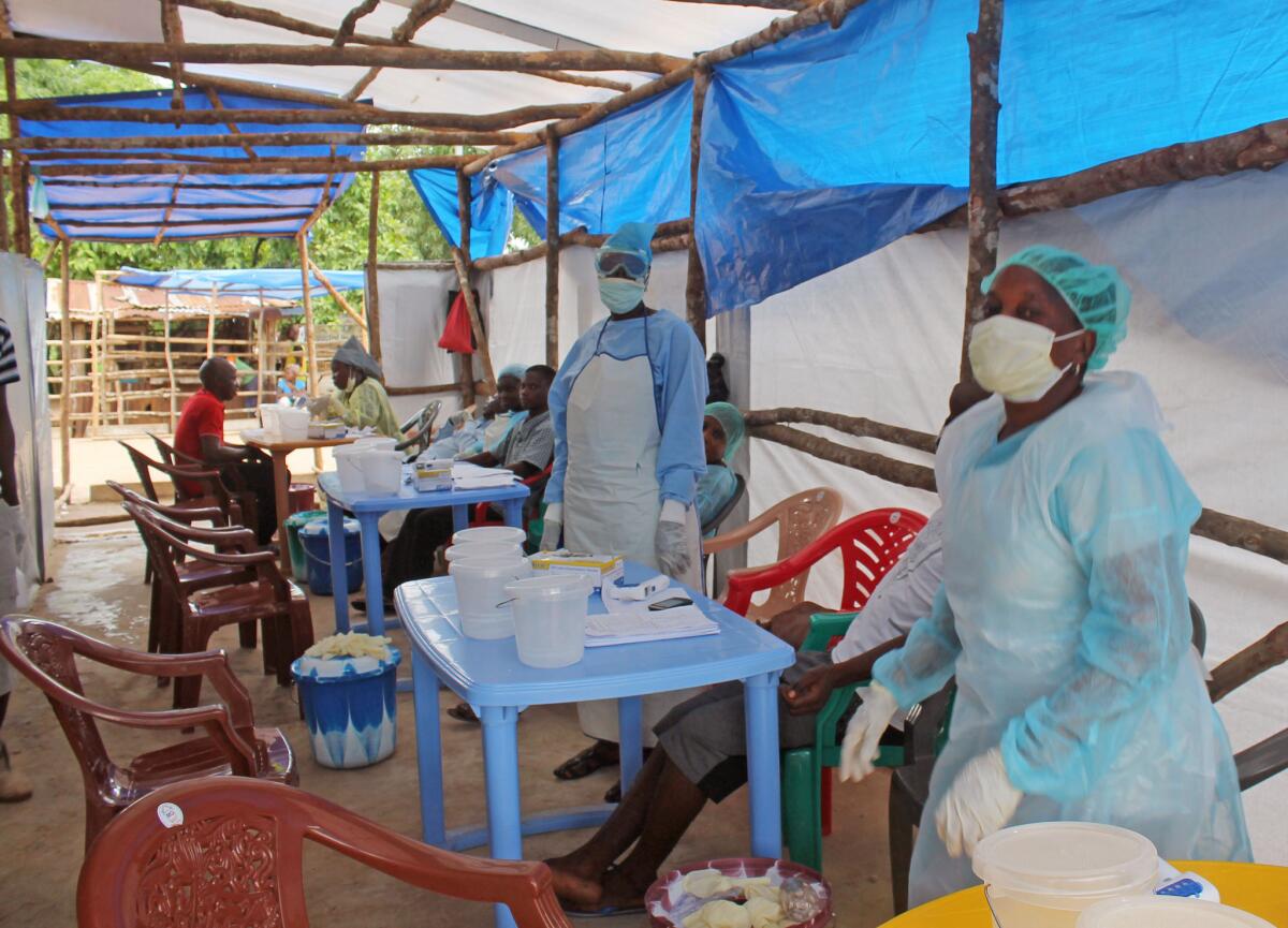 Medical personnel work at a clinic where Ebola patients are cared for on the outskirts of Kenema, Sierra Leone. A leading Sierra Leone doctor died of the disease July 29.