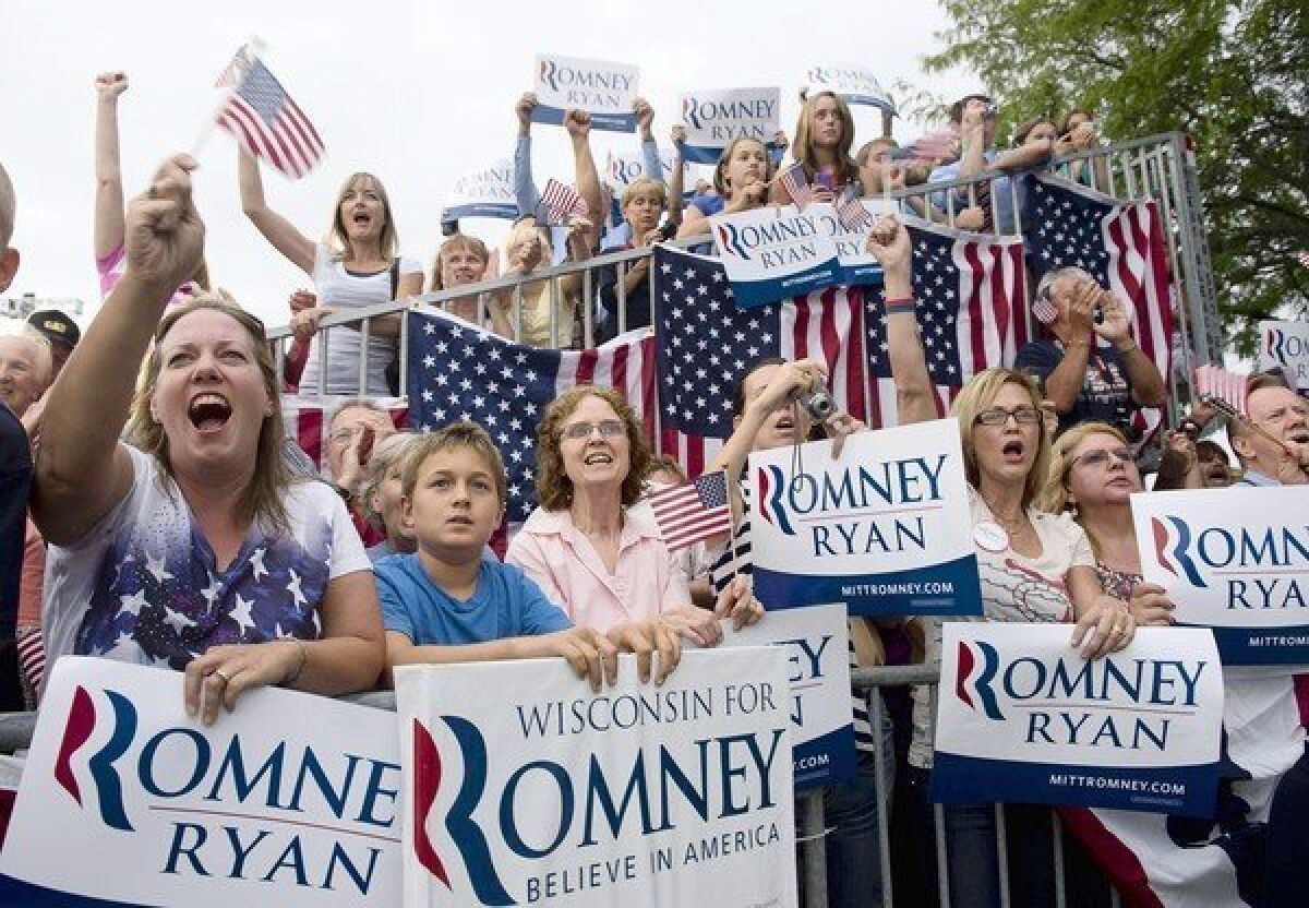 Supporters cheer for Mitt Romney and Paul Ryan in Waukesha, Wis. In a poll, 53% of state voters said that Romney doesn’t care about people like them.