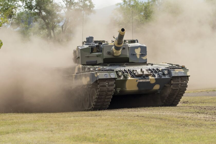 One of the new tanks is driven as a demonstration during the ceremonial handover of the first four Leopard 2A4HU tanks to the Hungarian army at an army baracks in Tata, Hungary, Friday, July 24, 2020. From September till the end of this year two Leopard tanks produced by the German firm Krauss-Maffei Wegmann will be delivered to the Hungarian defence Forces every month as Hungary buys 12 tanks of this type to replace Soviet made T72 tanks. (Csaba Krizsan/MTI via AP)